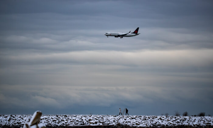 An Air Canada plane prepares to land at Vancouver International Airport, in Richmond, B.C., December 26, 2021. (The Canadian Press/Darryl Dyck