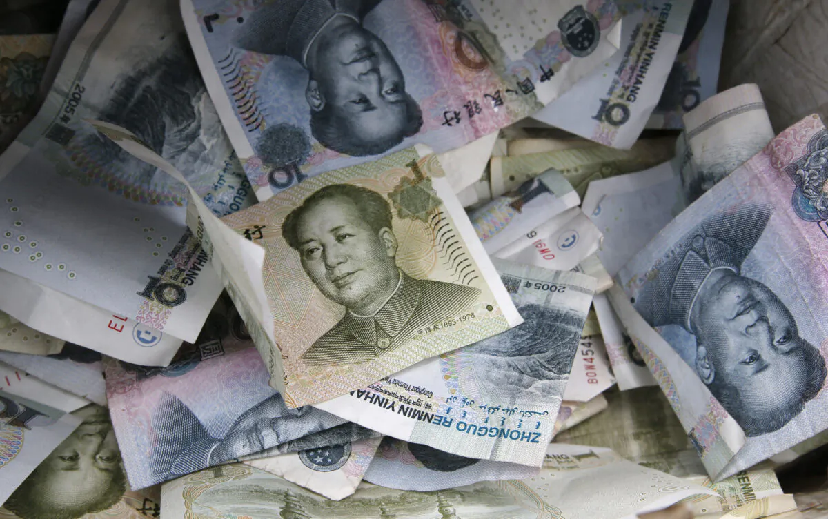 Chinese Yuan bank notes are seen at a vendor's cashbox, at a market in Beijing, China, on April 10, 2013. (Kim Kyung-Hoon/Reuters)