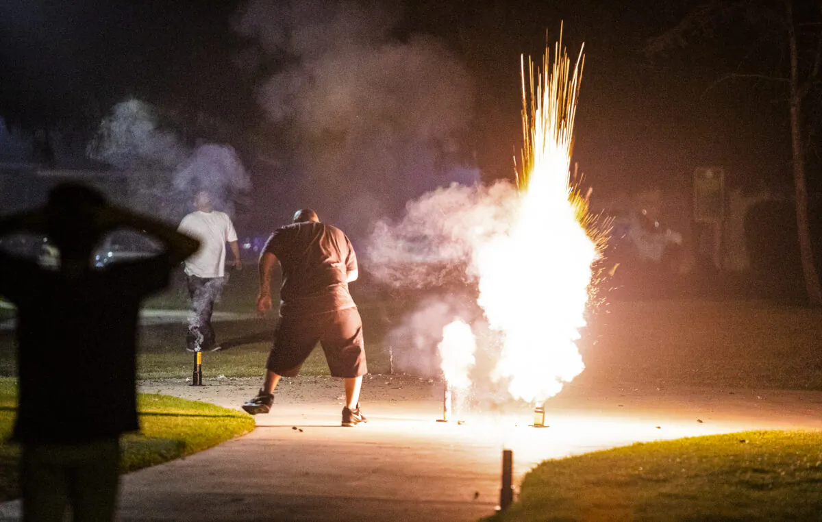 A family launches fireworks in Santa Ana, Calif., on July 4, 2020. (John Fredricks/The Epoch Times)