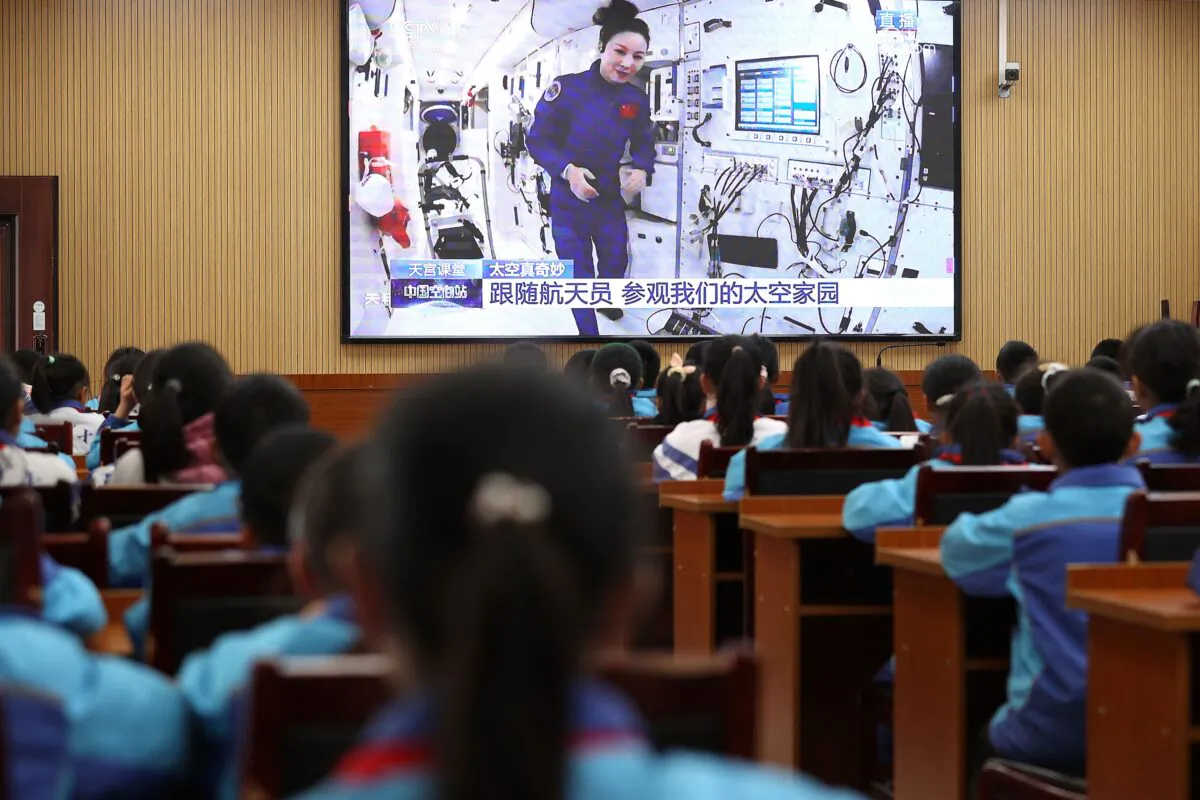 Students watch a lesson by Chinese astronauts from China's Tiangong space station, as part of the regime’s patriotism education, at a school in Danzhai in China's Southwestern Guizhou Province, on Dec. 9, 2021. (STR/AFP via Getty Images)