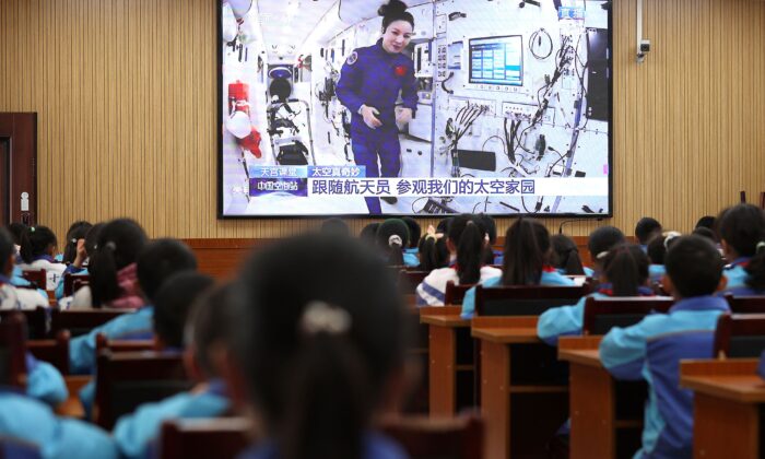 Students watch a lesson by Chinese astronauts from China's Tiangong space station, as part of the regime’s patriotism education, at a school in Danzhai in China's Southwestern Guizhou Province, on Dec. 9, 2021. (STR/AFP via Getty Images)