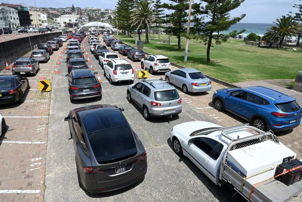 Residents queue up inside their cars for PCR tests at the St Vincent's Bondi Beach COVID-19 drive through testing clinic on December 22, 2021 in Sydney, as the number of COVID-19 cases keeps on the rise across the New South Wales state ahead of the Christmas festivities. (Photo by Mohammad Farooq/AFP via Getty Images)