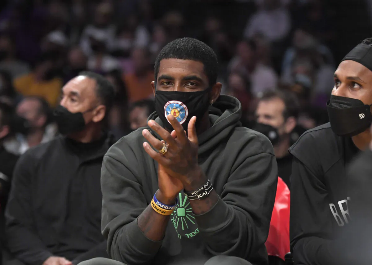 Kyrie Irving #11 of the Brooklyn Nets cheers from the bench during a preseason game against the Los Angeles Lakers at Staples Center in Los Angeles, on Oct. 3, 2021. (Kevork Djansezian/Getty Images)