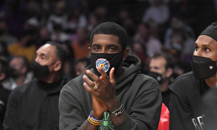 Kyrie Irving #11 of the Brooklyn Nets cheers from the bench during a preseason game against the Los Angeles Lakers at Staples Center in Los Angeles, on Oct. 3, 2021. (Kevork Djansezian/Getty Images)
