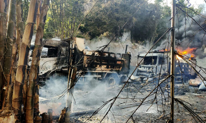 In this photo, provided by the Karenni Nationalities Defense Force (KNDF), smokes and flames billow from vehicles in Hpruso township, Kayah state, Myanmar, on Dec. 24, 2021. (KNDF via AP)