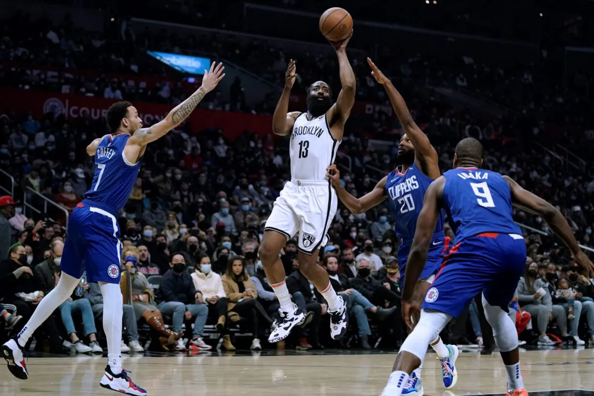 Brooklyn Nets' James Harden (C) shoots from between Los Angeles Clippers' Amir Coffey (L) and Justise Winslow during first half of an NBA basketball game in Los Angeles, on Dec. 27, 2021. (Jae C. Hong/AP Photo)
