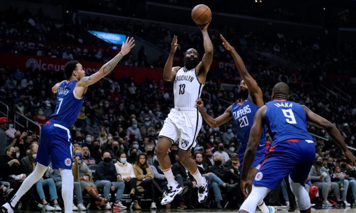 Brooklyn Nets' James Harden (C) shoots from between Los Angeles Clippers' Amir Coffey (L) and Justise Winslow during first half of an NBA basketball game in Los Angeles, on Dec. 27, 2021. (Jae C. Hong/AP Photo)