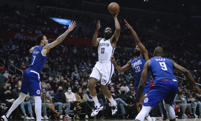 Brooklyn Nets' James Harden, center, shoots under pressure by Los Angeles Clippers' Amir Coffey, left, and Justise Winslow during first half of an NBA basketball game in Los Angeles on Dec. 27, 2021. (AP Photo/Jae C. Hong)