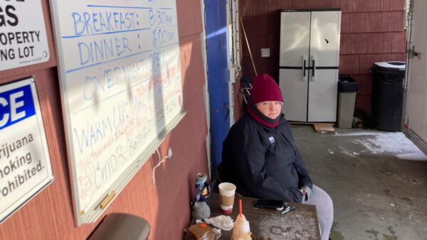 Kaety West sits outside the warming center