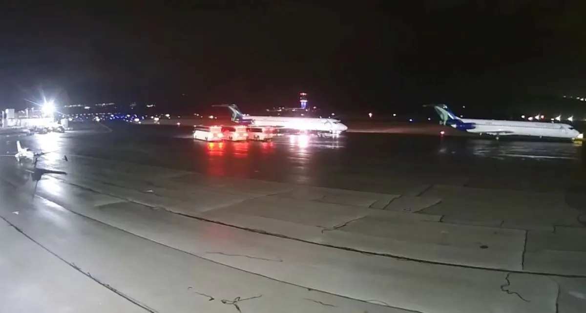 A plane drops off immigrant children at Scranton International Airport on Christmas night, Dec. 25. 2021, while three buses stand ready for their next leg of their journey. (Courtesy Jim Gallagher, Aviation Technologies)