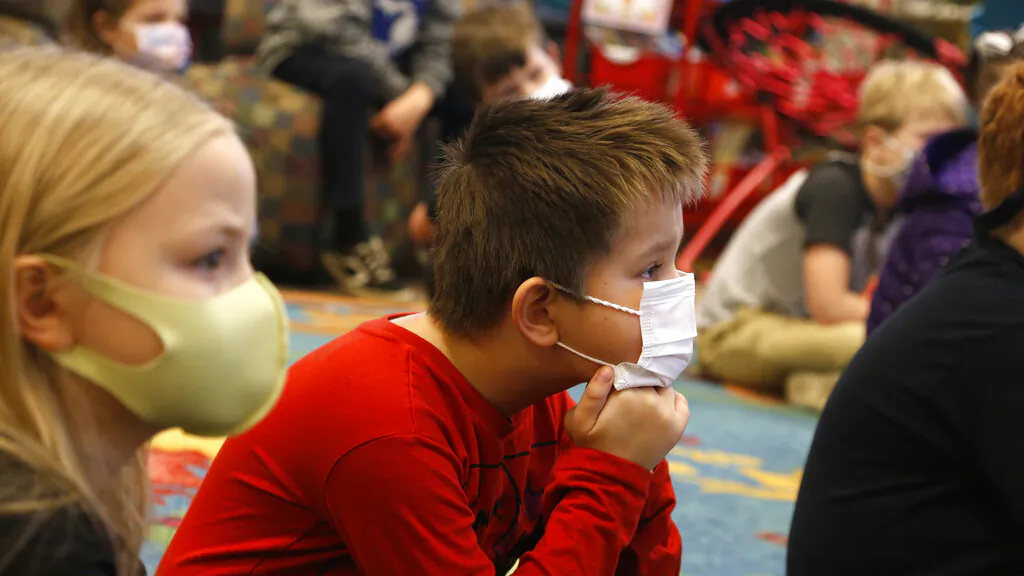 Second-graders listen to a lesson at Paw Paw Elementary School on Thursday, Dec. 2, 2021, in Paw Paw, Michigan. (AP Photo/Martha Irvine)