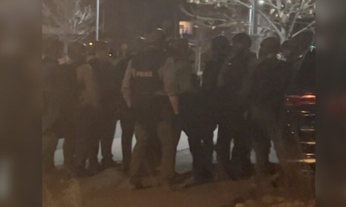 Officers gather in the street in Lakewood, Colo., on Dec. 27, 2021, in this still image taken from a social media video. (Hawk Hawkins/via Reuters)