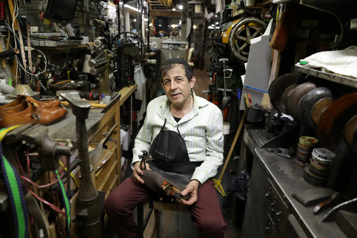 Uriel Gurgov works on repairing a shoe in his workshop. (Lux Aeterna Photography for American Essence)