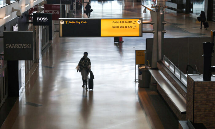 Air travelers walk through a terminal as the coronavirus disease (COVID-19) outbreak continues, at New York’s JFK International Airport in New York, U.S., May 15, 2020. (REUTERS/Shannon Stapleton)