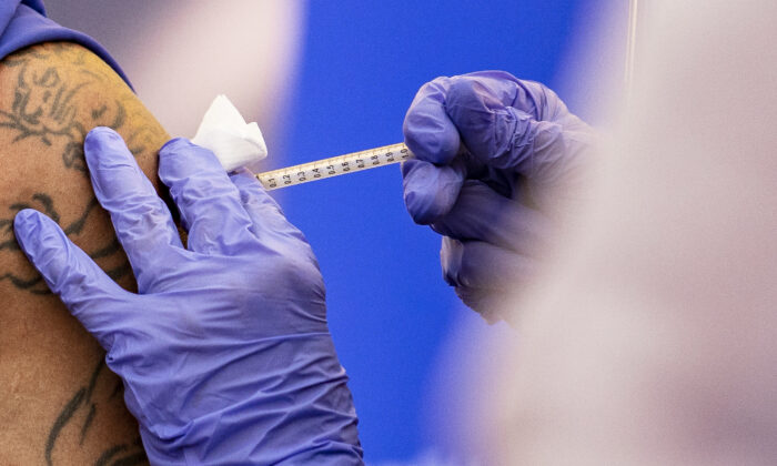 A COVID-19 vaccine is administered in Orange, Calif., on Dec. 16, 2020. (John Fredicks/The Epoch Times)