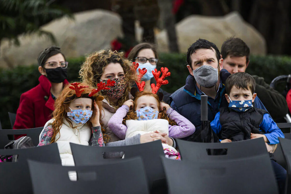 A family wears protective masks in Garden Grove, Calif. on Dec. 24, 2020. (Patrick T. Fallon / AFP via Getty Images)