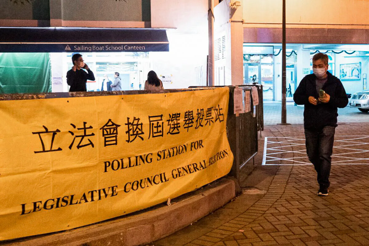 A voter leaves a polling station during the Legislative Council election in Hong Kong's Choi Hung area on Dec. 19, 2021. (Bertha Wang/AFP via Getty Images)