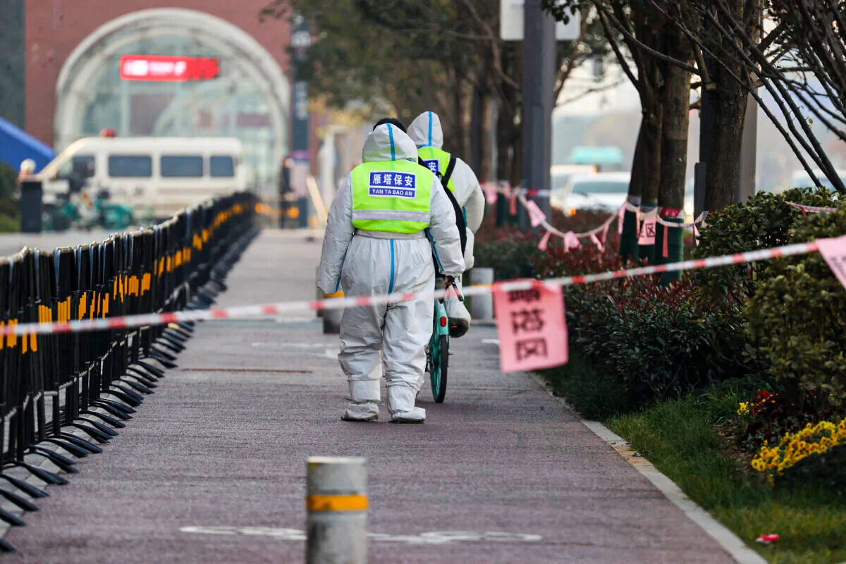 Security guards walking in a restricted area following a recent COVID-19 outbreak in Xi'an city of Shaanxi Province, China, on Dec. 22, 2021. (STR/AFP via Getty Images)