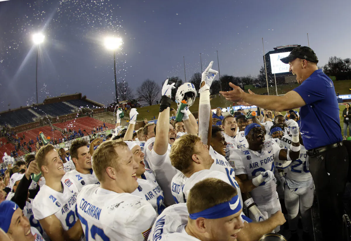 Head coach Troy Calhoun of the Air Force Falcons celebrates with his team after they defeated the Louisville Cardinals 31-28 in the First Responders Bowl at Gerald J. Ford Stadium in Dallas on Dec. 28, 2021. (Ron Jenkins/Getty Images)