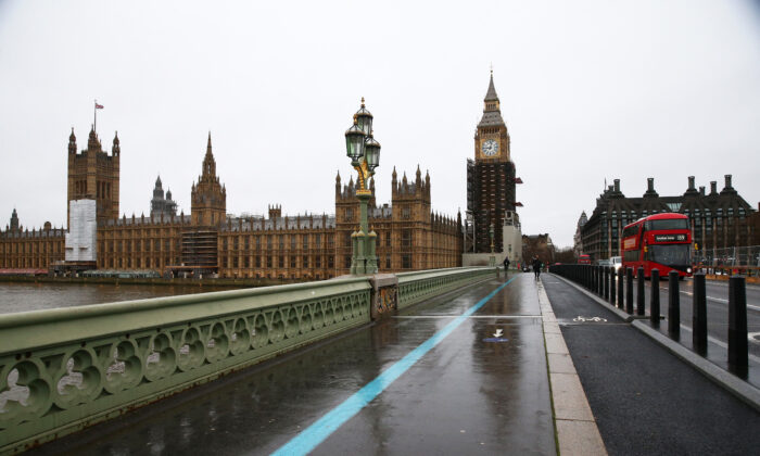 A bus goes past the Houses of Parliament and Big Ben in London on Dec. 29, 2021. (Hollie Adams/AFP via Getty Images)