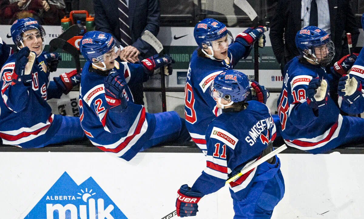 United States' Mackie Samoskevich (11) celebrates his goal against Slovakia with his teammates, during an IIHF World Junior Hockey Championship game in Red Deer, Alberta, on Dec. 26, 2021. (Jonathan Hayward/The Canadian Press via AP)