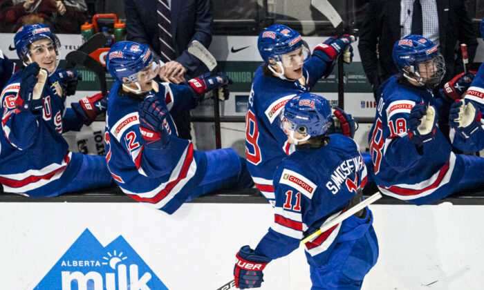 United States' Mackie Samoskevich (11) celebrates his goal against Slovakia with his teammates, during an IIHF World Junior Hockey Championship game in Red Deer, Alberta, on Dec. 26, 2021. (Jonathan Hayward/The Canadian Press via AP)