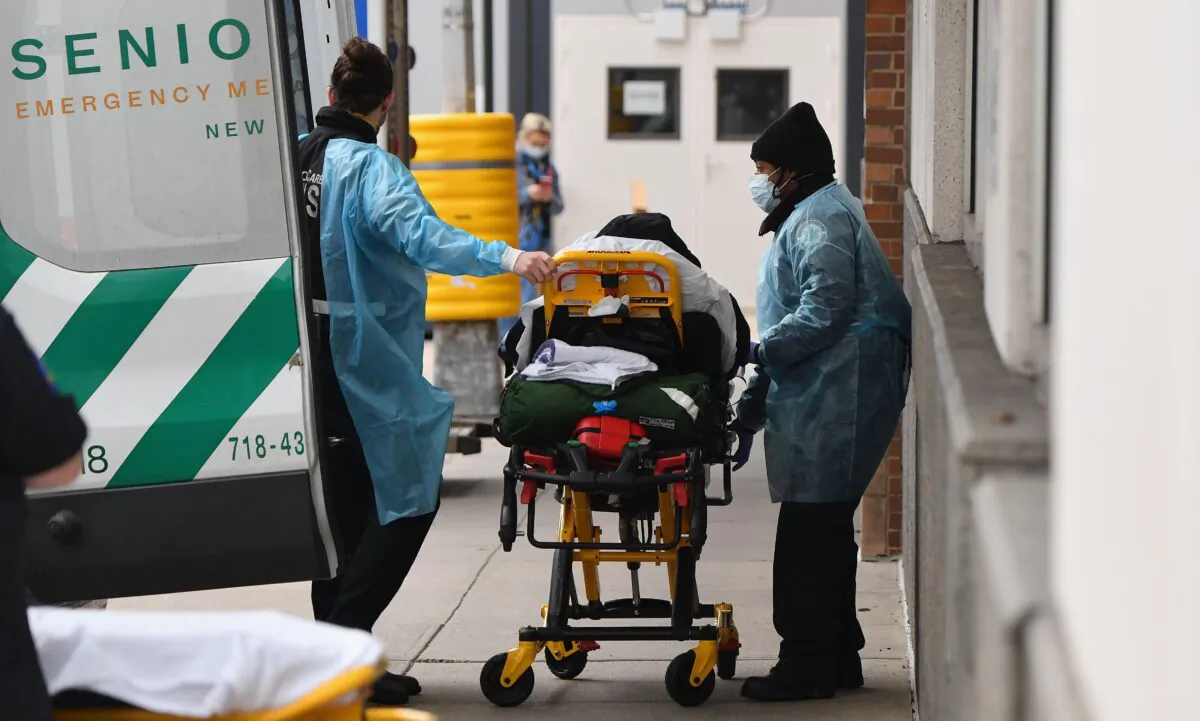 Healthcare workers transport a patient from an ambulance to Maimonides Medical Center, a hospital in the Brooklyn neighborhood of Borough Park in New York City on Jan. 4, 2021. (Angela Weiss/AFP via Getty Images)