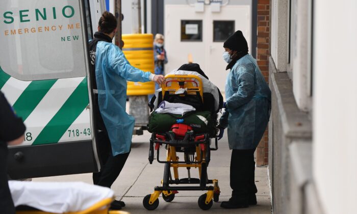 Healthcare workers transport a patient from an ambulance to Maimonides Medical Center, a hospital in the Brooklyn neighborhood of Borough Park in New York City on Jan. 4, 2021. (Angela Weiss/AFP via Getty Images)