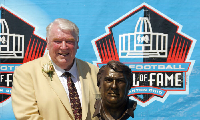 Broadcaster and former Oakland Raiders coach John Madden poses with his bust after enshrinement into the Pro Football Hall of Fame, in Canton, Ohio, on Aug. 5, 2006. (Mark Duncan/AP Photo)