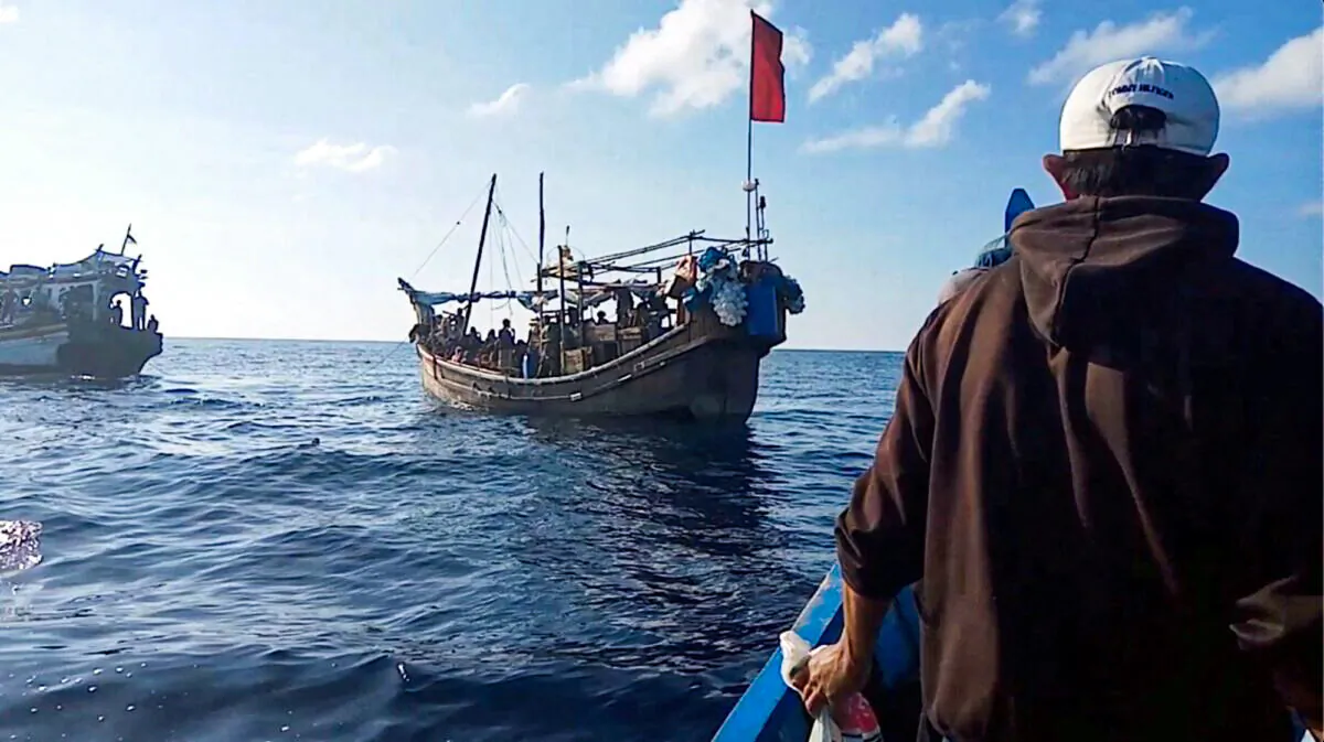 A boat carries Rohingya people stranded at sea near Indonesia on Dec. 27, 2021. (Aditya Setiawan/Reuters)