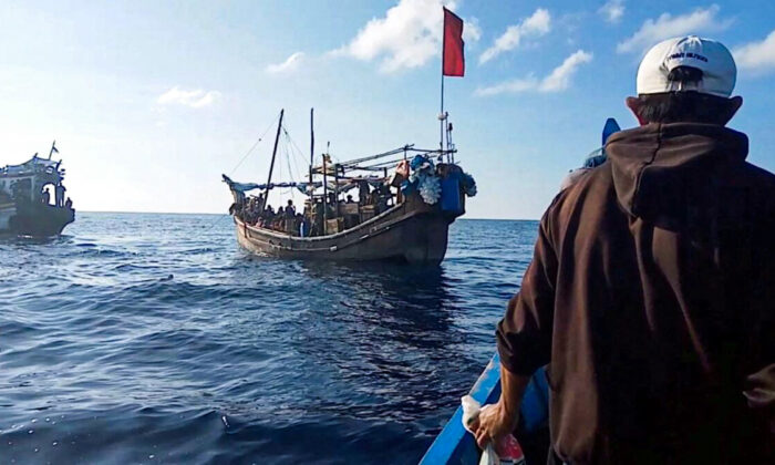 A boat carries Rohingya people stranded at sea, Indonesia, on Dec. 27, 2021. (Aditya Setiawan/ Reuters)