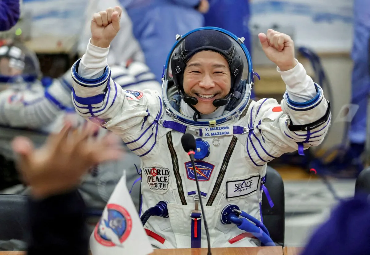 Japanese entrepreneur Yusaku Maezawa reacts as he speaks with his family after donning space suits shortly before the launch to the International Space Station (ISS) at the Baikonur Cosmodrome, Kazakhstan, on Dec. 8, 2021. (Shamil Zhumatov/Reuters)