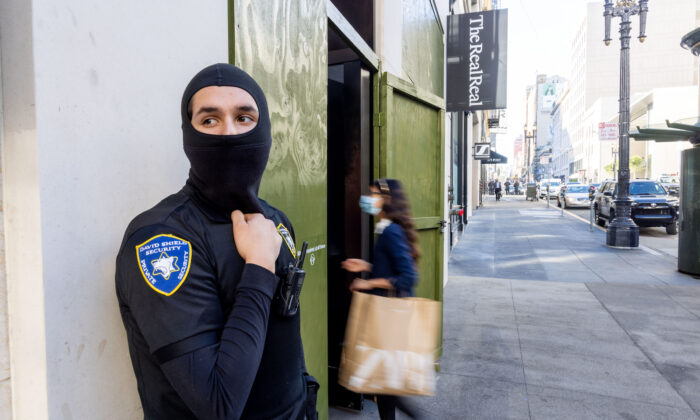 A security guard keeps watch outside The Real Real store near Union Square in San Francisco on Nov. 30, 2021. (Ethan Swope/Getty Images)