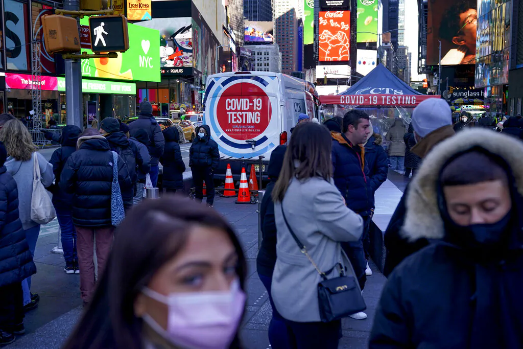 People wait in a long line to get tested for COVID-19 in Times Square, N.Y., Dec. 20, 2021. (Seth Wenig/AP Photo)