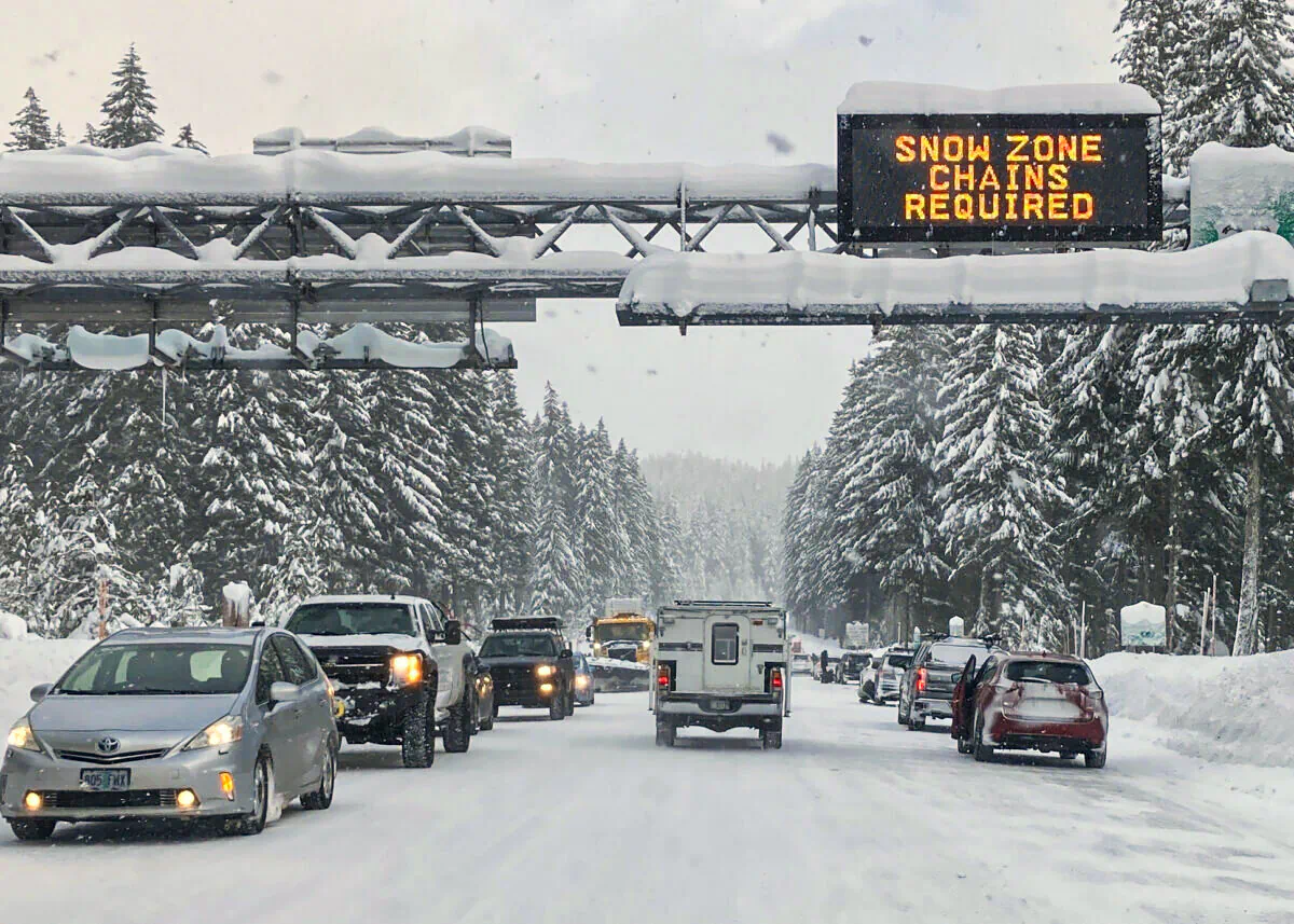 Heavy traffic is seen at the base of a snowy Santiam Pass in Detroit, on Dec. 26, 2021. (Andrew Selsky/AP Photo)