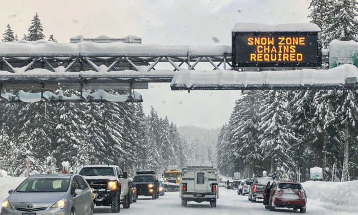 Heavy traffic is seen at the base of a snowy Santiam Pass in Detroit, on Dec. 26, 2021. (Andrew Selsky/AP Photo)