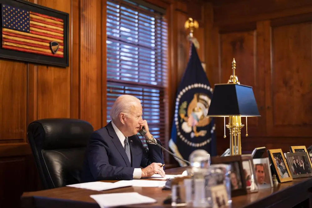 In this image provided by The White House, President Joe Biden speaks with Russian President Vladimir Putin on the phone from his private residence in Wilmington, Del., on Dec. 30, 2021. (Adam Schultz/The White House via AP)