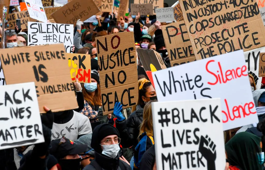 People hold up placards at a Black Lives Matter protest to express solidarity with U.S. protestors in Melbourne on June 6, 2020. (William West/AFP via Getty Images)