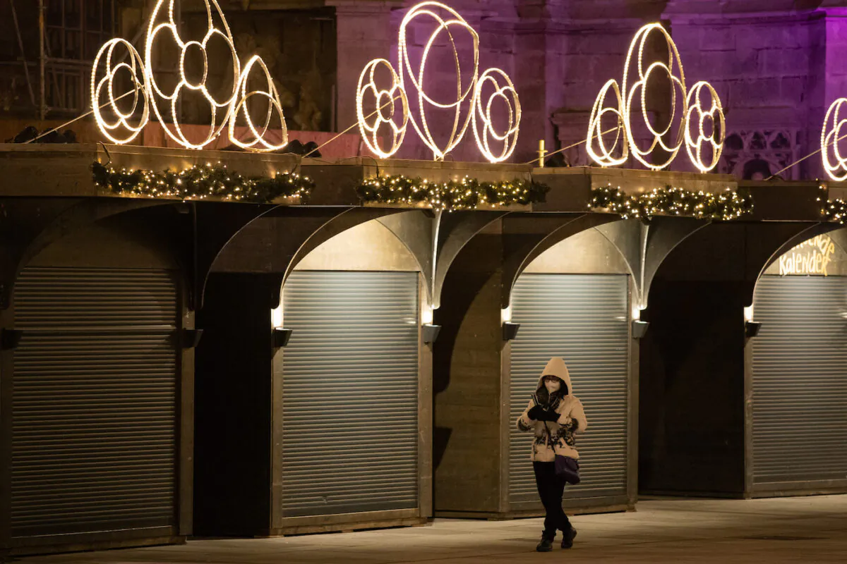 A person walks past closed Christmas market stalls on Stephansplatz on the third day of a nationwide, temporary lockdown during the fourth wave of the novel coronavirus pandemic on Nov. 24, 2021, in Vienna, Austria. (Thomas Kronsteiner/Getty Images)