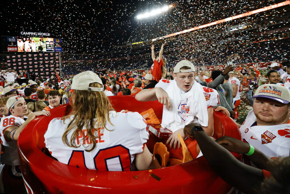 Luke Price #40 of the Clemson Tigers and Bryan Bresee #11 celebrate after defeating the Iowa State Cyclones in the Cheez-It Bowl Game at Camping World Stadium, in Orlando, on Dec. 29, 2021. (Douglas P. DeFelice/Getty Images)