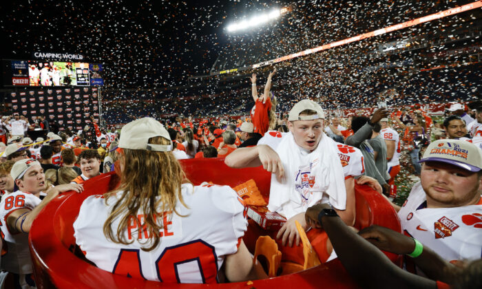 Luke Price #40 of the Clemson Tigers and Bryan Bresee #11 celebrate after defeating the Iowa State Cyclones in the Cheez-It Bowl Game at Camping World Stadium, in Orlando, on Dec. 29, 2021. (Douglas P. DeFelice/Getty Images)