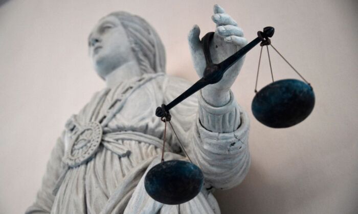 A statue of the goddess of Justice balancing the scales at Rennes' courthouse in Brittany, France, on May 19, 2015. (DAMIEN MEYER/AFP via Getty Images)