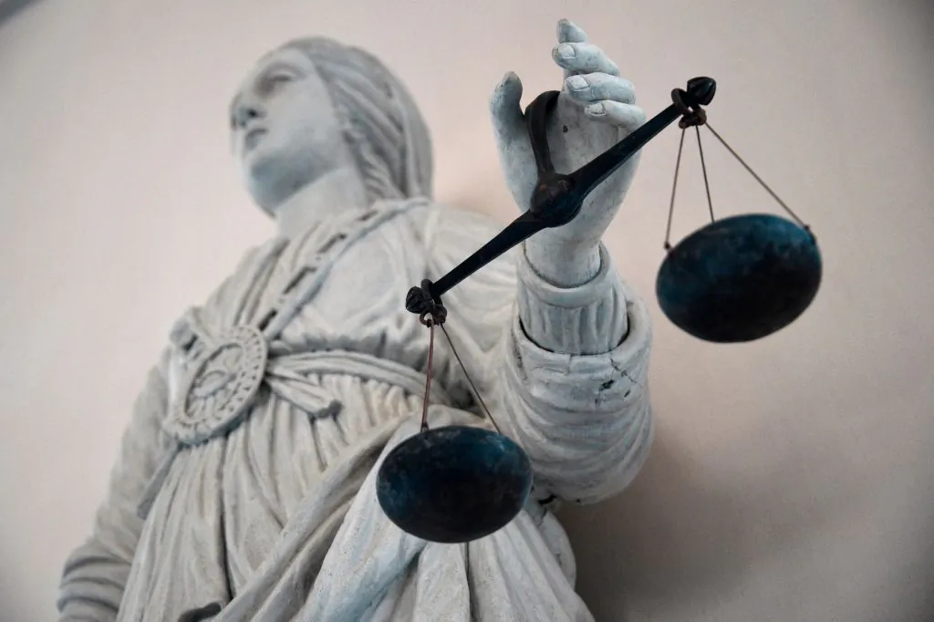 A statue of the goddess of justice balancing the scales, at a courthouse in Rennes, France, on May 19, 2015. (DAMIEN MEYER/AFP via Getty Images)