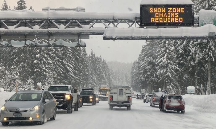 Heavy traffic is seen at the base of a snowy Santiam Pass in Detroit, Ore., on Dec. 26, 2021.(Andrew Selsky/AP Photo)