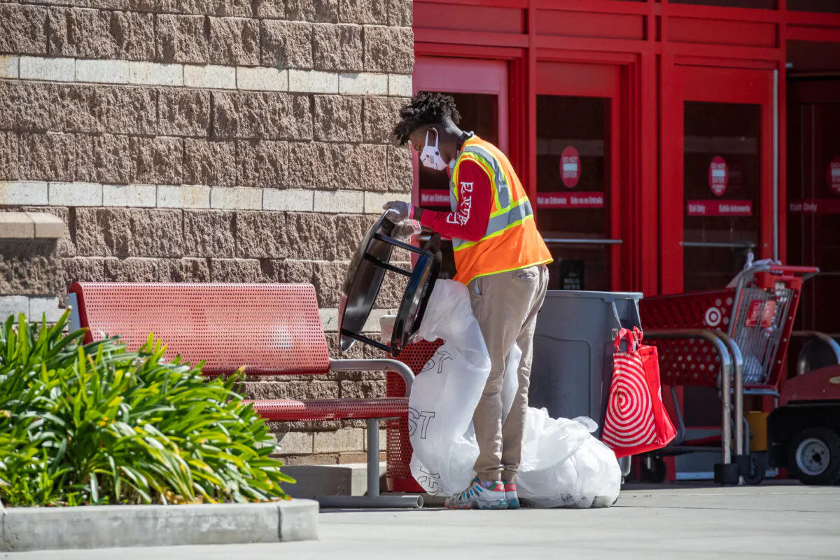 A Target worker cleans up trash in Costa Mesa, Calif. on March 1, 2021. (John Fredricks/The Epoch Times)