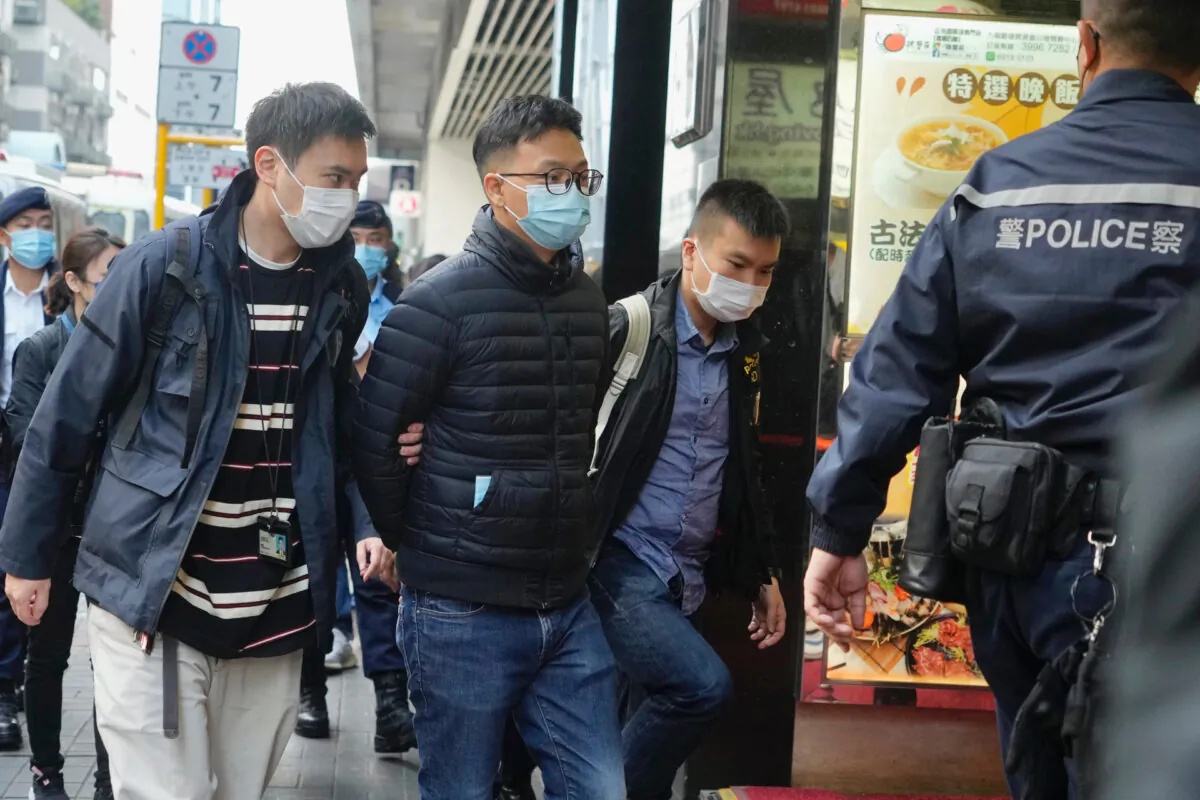 Editor of "Stand News" Patrick Lam, second from left, is arrested by police officers in Hong Kong on Dec. 29, 2021. (Vincent Yu/AP Photo)

