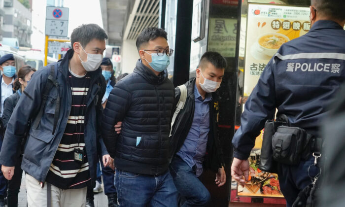 Editor of Stand News, Patrick Lam (second from left) is arrested by police officers in Hong Kong on Dec. 29, 2021. (Vincent Yu/AP Photo)
