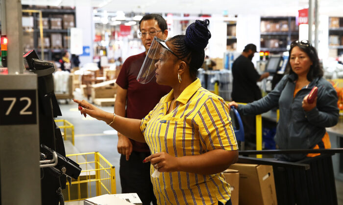 Staff at the checkout are seen in Ikea on June 01, 2020 in London, England. (Julian Finney/Getty Images)