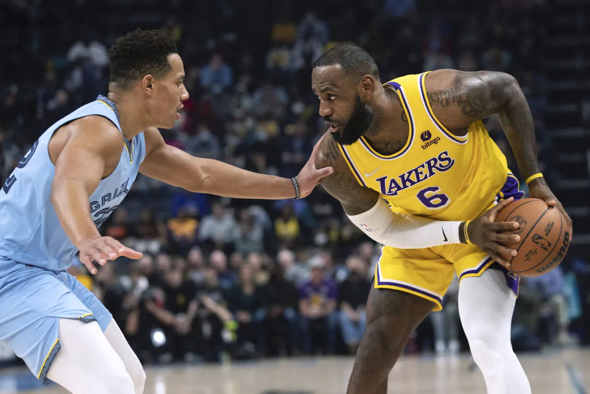 Memphis Grizzlies guard Desmond Bane (22) defends Los Angeles Lakers forward LeBron James (6) in the first half of an NBA basketball game in Memphis, Tenn., on Dec. 29, 2021. (AP Photo/Nikki Boertman)