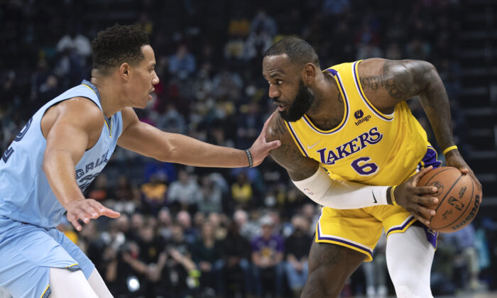 Memphis Grizzlies guard Desmond Bane (22) defends Los Angeles Lakers forward LeBron James (6) in the first half of an NBA basketball game in Memphis, Tenn., on Dec. 29, 2021. (AP Photo/Nikki Boertman)